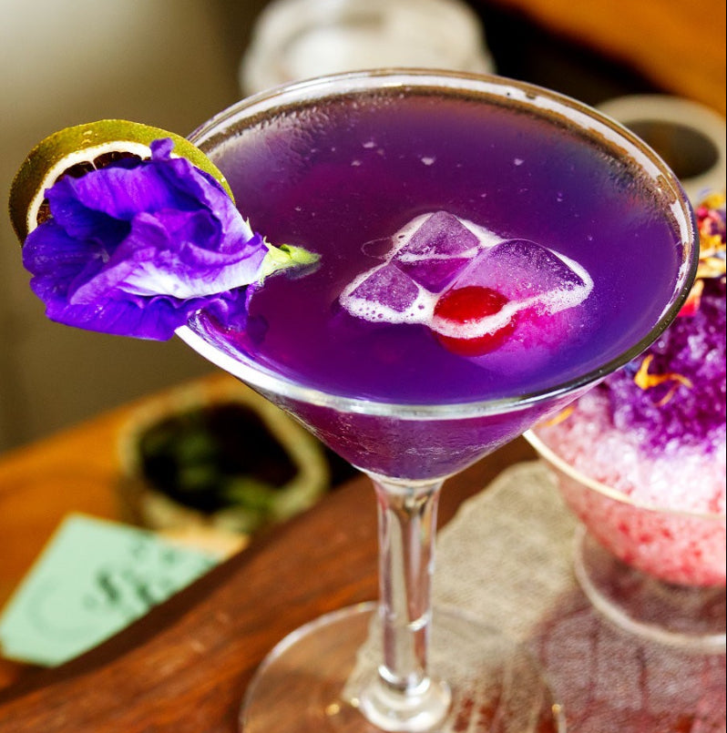 Load video: Luscious purple cocktail slowly being poured from a bar tap